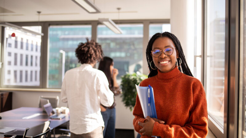 Black girl in office in considering a distance learning degree.