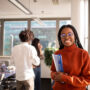 Black girl in office in considering a distance learning degree.