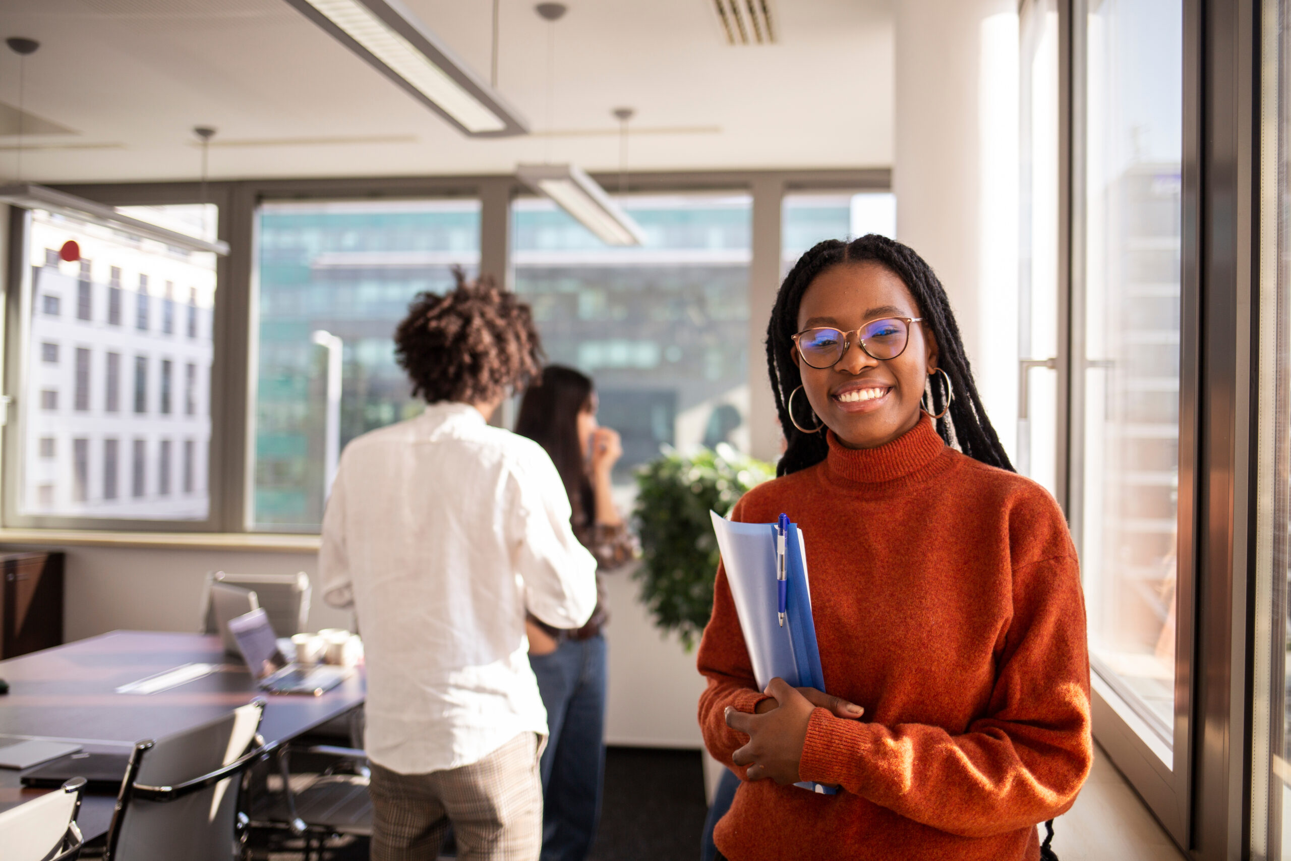 Black girl in office in considering a distance learning degree.